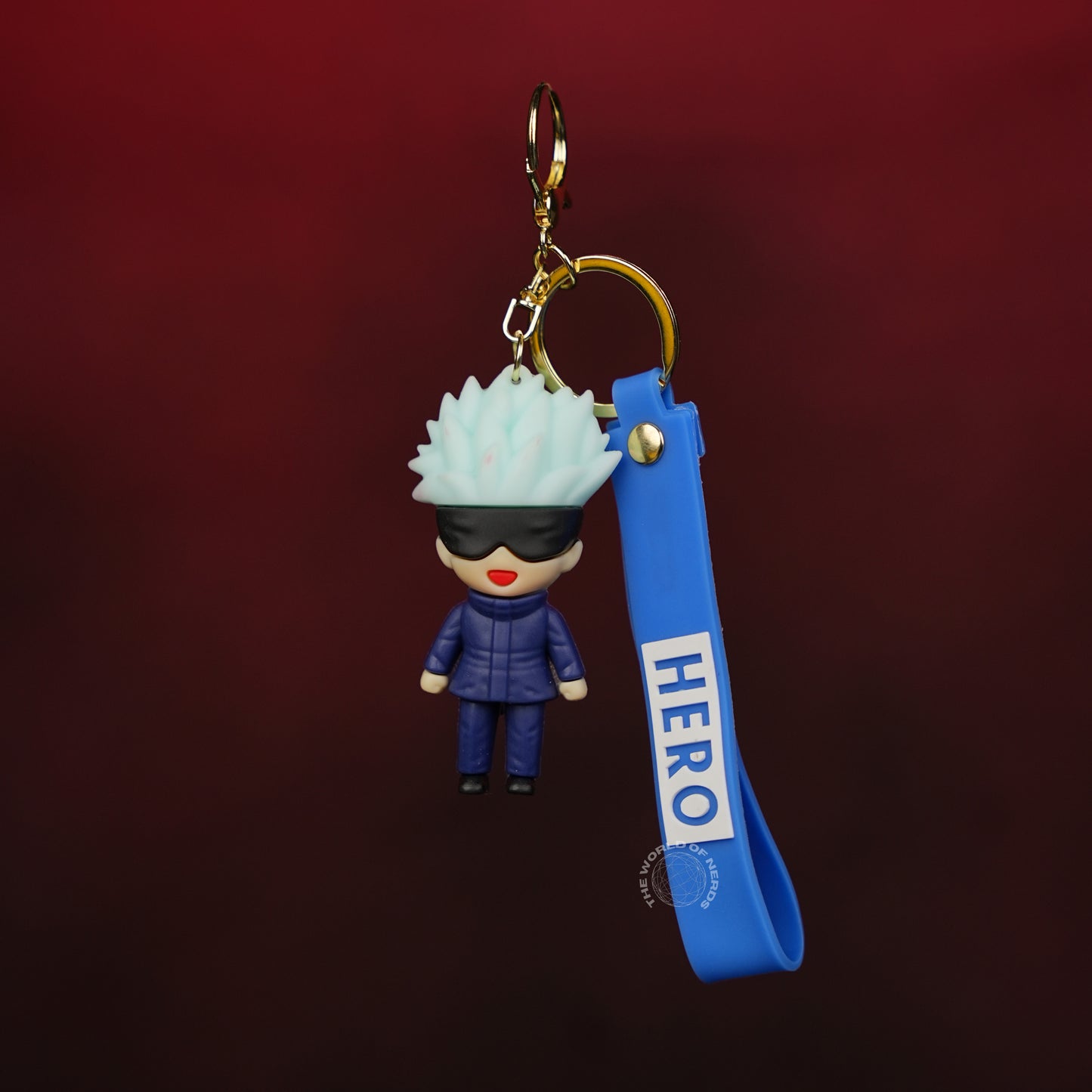 Keychain with a character wearing a blue outfit and helmet, attached to a blue strap with 'HERO' text on a dark red background.