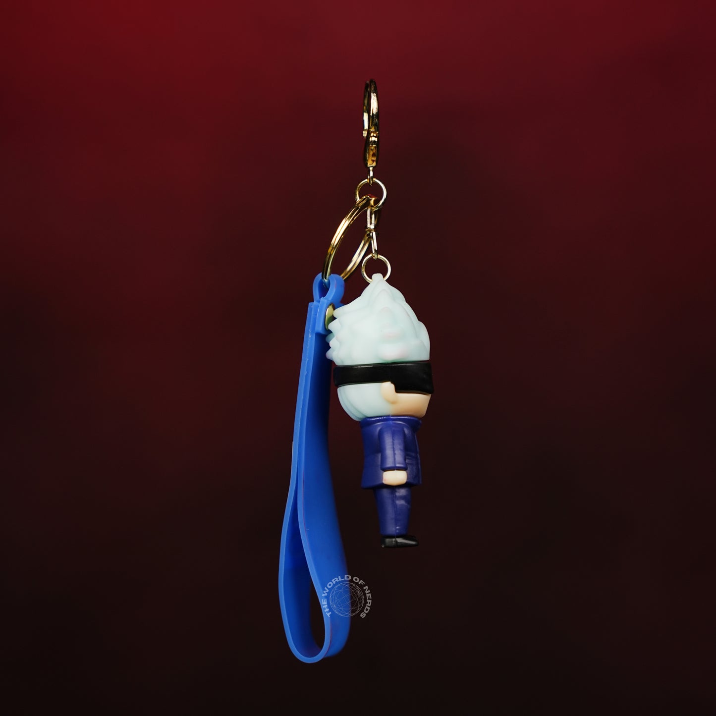 Keychain with blue strap and character design on a dark background